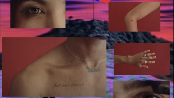 Still from "Montgomery County" teaser featuring a chest with "blush" tattooed across it